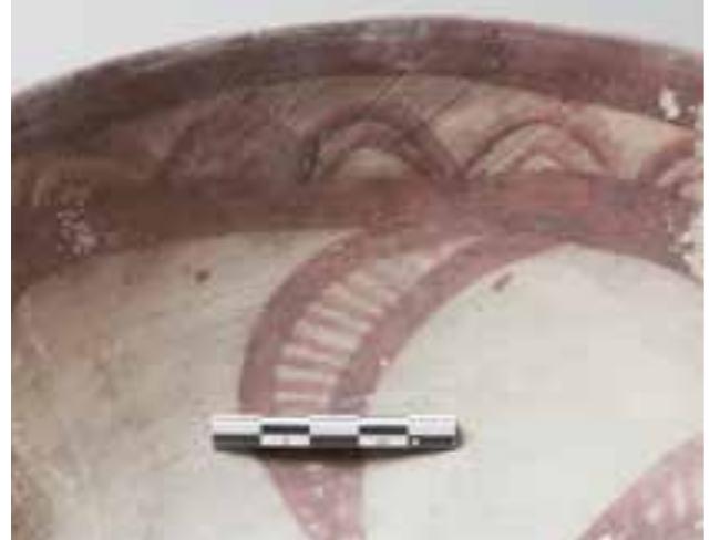 Medium-sized bowl! with outward-turned rim and flat base. A thick horizontal band and double-contoured, hanging interlaced loops decorate the outer upper surface. The inner surface shows a frieze with broad bands and 15 double-contoured standing loops. Visible in the centre is a swastika-like motif composed of four hatched arms. Similar examples were found on Dasht Plain sites dated to the Late Period llla.  See: Mutin 2007, Figs. Il, 276; Il, 279  Doc. No. 0444-117  The Kech Makran Region in Protohistoric Times. Catalogue 