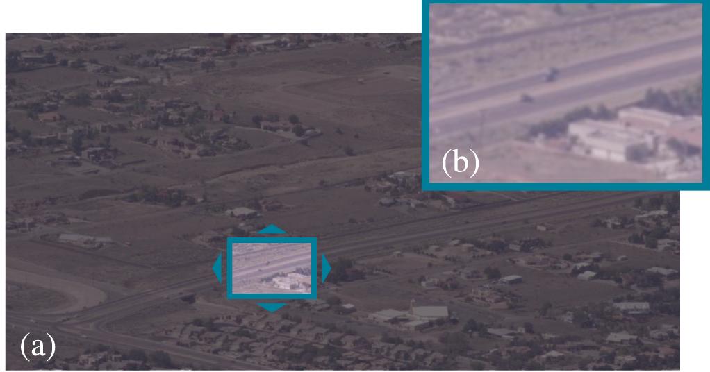Fig. 1. Example video frame (a), artificially windowed to emulate smaller, movable FoV, which is enlarged in (b) to show detail.  "1  The cell-MB SWT framework is demonstrated in a vehi- cle tracking problem using real video data. The video was recorded using a fixed camera with a large FoV (Fig. 1.a), and real-time FoV controlled motion was simulated by windowing the data over a small fraction of the image, as illustrated in Fig. 1.b. This dataset presents significant tracking challenges, including jitter-induced noise and clutter, unknown measure- ment origin, merged detections from closely-spaced vehicles, and most significantly, temporal sparsity of detections.   A. Vehicle Dynamics 