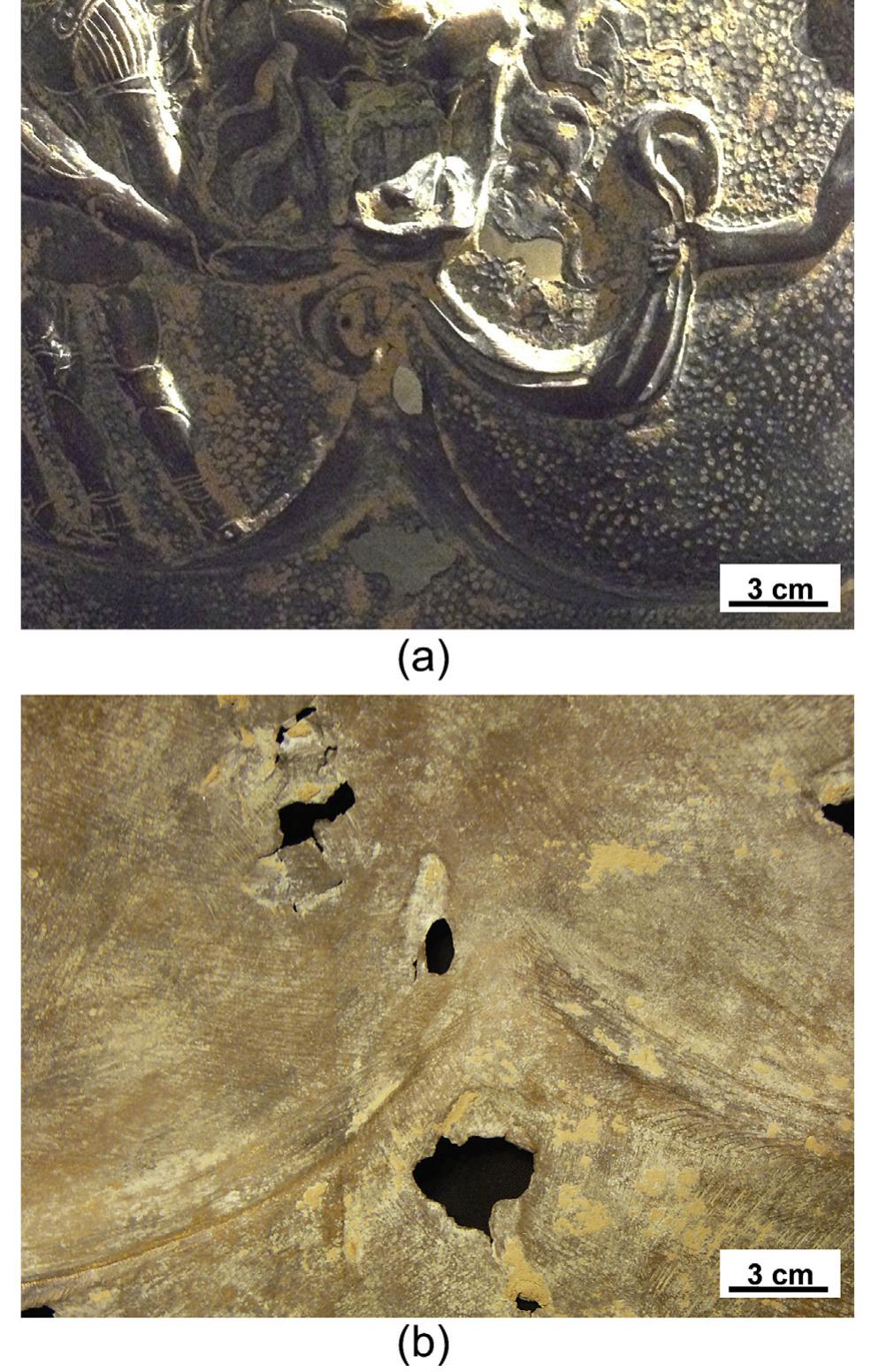 Fig. 8. Macroscopic images of the front (a) and the back (b) of the muscled cuirass, showing the presence of earthy deposits on surface undercuts and the absence of repoussé work.
