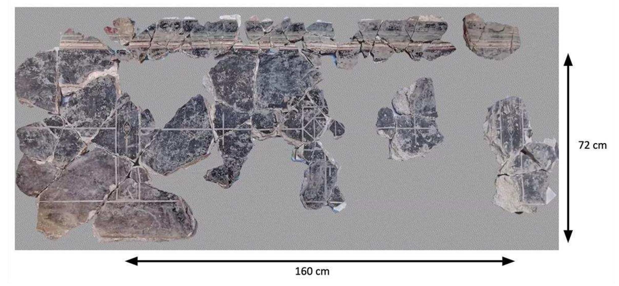 Fig. 28. VPP 2019, Trench C: Recomposed socle in Pompeian Third Style (Group 1) (Photo: |. Varriale; D. Diffendale).  Of the approximately 400 fragments collected from the fills, 70% belong to a socle in Pompeian Third Style (Group 1). Around 100 fragments could be reassembled (fig. 28), for a total length of 2 m. The lower register consists of a shallow plinth (0.15 m) and taller socle (0.57 m), both having a black background separated by a white line. The geometric decoration features a series of panels framed by partitions bordered by two lines in light gray and gold enclosing a central volute motif in gold. The central panel, measuring 1.42 m (or 1.60 m in- cluding the partitions), also preserves parts of the connection between the socle and main zone (0.18 m), for a total height of about 0. 90 m. Its main motif features interlaced squares forming triangles inscribed with gold ro- settes; two stylized stems branch vertically off the central motif. 