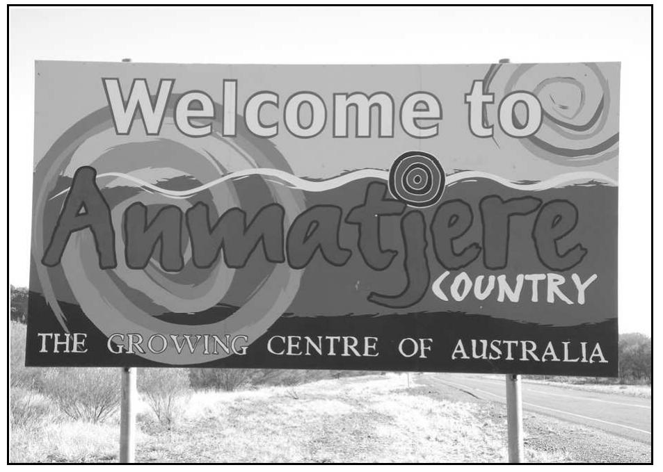 Figure 17.2 Sign on Stuart Highway south of Aileron (photo J. Green)  Language names are often used to name Aboriginal councils (Anmatjere Council,  Alyawarr Ingkerrewenh), and local landmarks such as ‘Anmatjere man’, a prominant sculpture situated at Aileron (see Map 17.1). As such they emphasise regional identity  rather than a language variety of communica  ion. One example of this are the signs  welcoming people to Anmatyerr country (Figure 17.2). In Anmatyerr communities most people speak Anmatyerr as well as a variety of English, and some speak Warlpiri as well.  Given this linguistic complexity these signs c  early associate a language name with a  geographic area rather than indicating the languages in use in the area. 