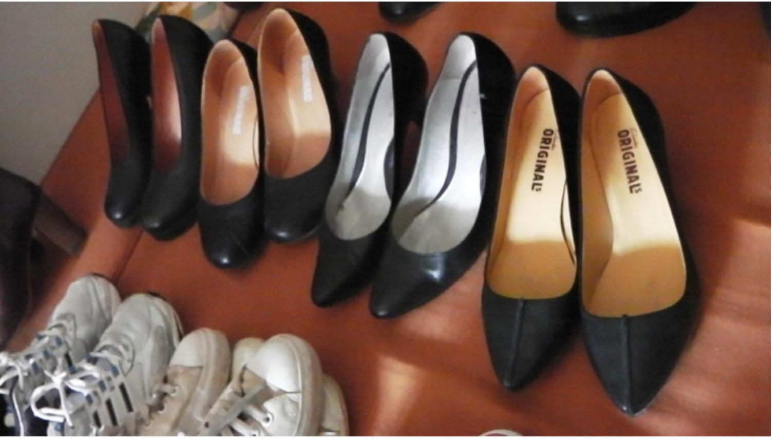 -ig.6.14: Part of Marijke’s personal shoe collection at her home in Somerset. Still from interview video.  Here, Stewart’s theories about collecting are useful to understand the process of embodiment and identification through representation. In this case, the collection is understood as an intentional and curated accumulation of items relating to a theme (as opposed to the unintentional practice of hoarding). Like Bourdieu and his notion of embodied capital, Stewart explains the collection cannot be purchased ‘in toto’, instead it must be serially acquired over a period of time. Consequently ‘[t]his seriality provides a means for defining or classifying the collection and the collector’s life history [...] “Earning” the collection simply involves waiting, creating the pauses that articulate the biography of the collector’ (Stewart, 1993: 166). As such Brydon explains, the ‘act of collecting manifests the maturing of the individual’s self-identity’, it this case, of the footwear designer, where: ‘[c]ollecting not only expresses who they are, it participates in the process of locating their sense of self in the flux of experience’ (Brydon, 1995 16). Furthermore, Stewart suggests the practice of organizing and classifying the collection is as important as the items themselves in this process of locating a sense of self. Although | was not able to view Mirijke’s full collection, she kept many pairs of her own shoes at her house near Street where her second interview was conducted. On arrival, the shoes were laid out on the floor. She explained that they weren’t categorized, although as we were discussing them she started classifying them according to their type and function (fig. 6.14) — once again her ethos and commitment to simplicity and quality emerged where her professional and personal shoe practices could be seen to be co-constitutive.  