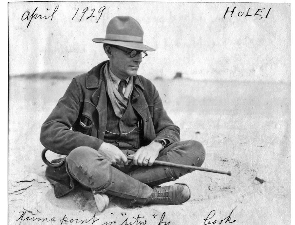 Figure 4. Perry Andersen pointing to a “Yuma” point in situ at his Hole #1 site, Yuma County, Colorado, April 1929. (Photo by Harold J. Cook.) The point is a Scottsbluff spear point, removed in a block of sediment by Andersen. (Image courtesy of the University of Nebraska State Museum.)  Figure 3. Representative sample of the Andersen family collection (1920s—1930s) from the dune fields of Yuma County, Colorado (LaBelle 2005). Collection housed at the University of Nebraska State Museum. (Photo by Jason LaBelle.) 