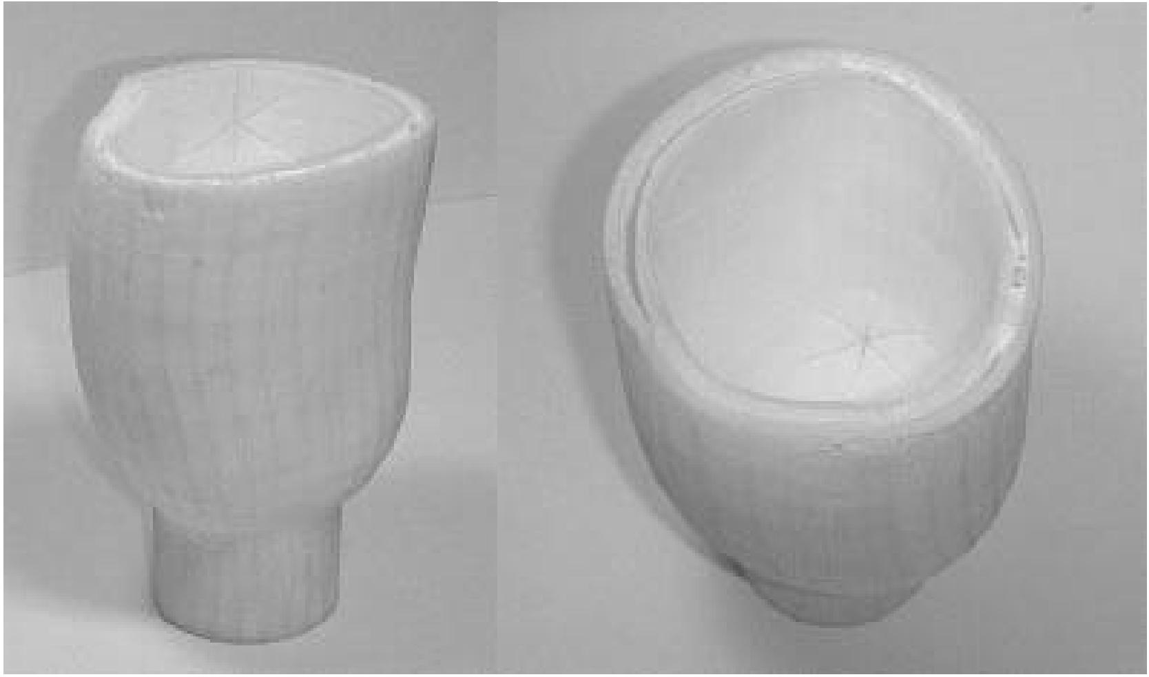 A test socket was first produced in the UT Austin Laboratory for Freeform Fabrication using about 75% virgin Duraform and 25% once recycled Duraform. The SLS workstation is an older prototype version that cannot fabricate the entire socket due to height limitations. Figure 7 shows the bottom portion of the socket that was fabricated. In the left view, the fibular head hex-  slot and the dual wall construction are visible. . In the right view, the tibial compliance element and the supports can be seen. 