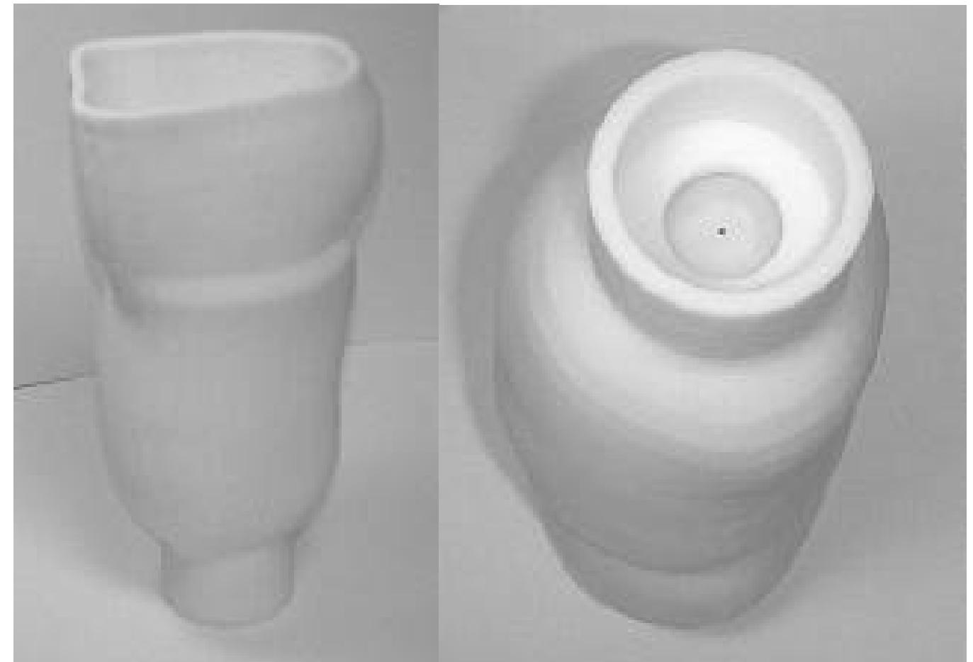 clearance between the cantilever features in the compliance elements is larger than required when producing the socket on a late model DTM Sinterstation™. In fact, the slots were produced so well there was a concern about the sharpness of the edges and points causing pinching on the patient. Future designs will need to be filleted in this region with a smaller slot  width.  Figure 8. Side and bottom views of final socket after SLS fabrication. 