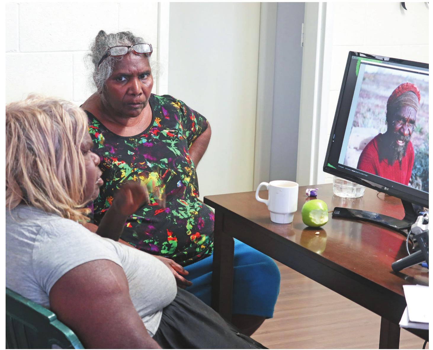 Figure 2. Norma Giles and Lizzie Ellis discuss an archival image from the lan Dunlop Collection  (AIATSIS: DUNLOP_113_CS-000137776) taken in 1965 (photo: Jennifer Green) 
