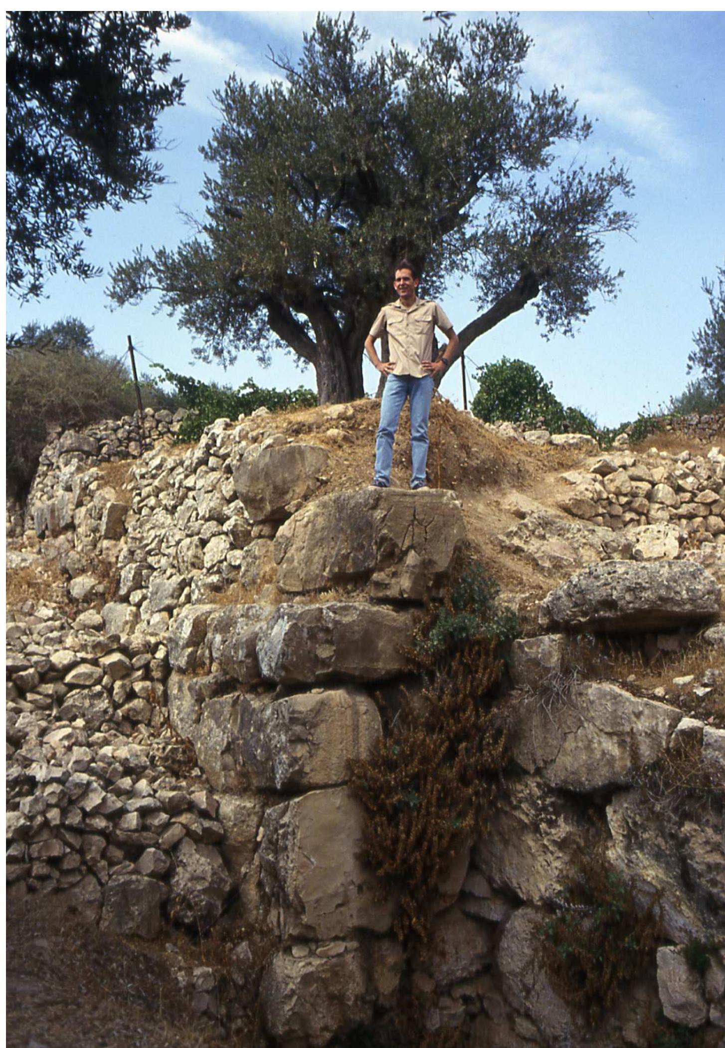JEFFREY CHADWICK standing on the Cyclopean Wall in Area I.3; CHADWICK 2005, fig. on p. 28. 