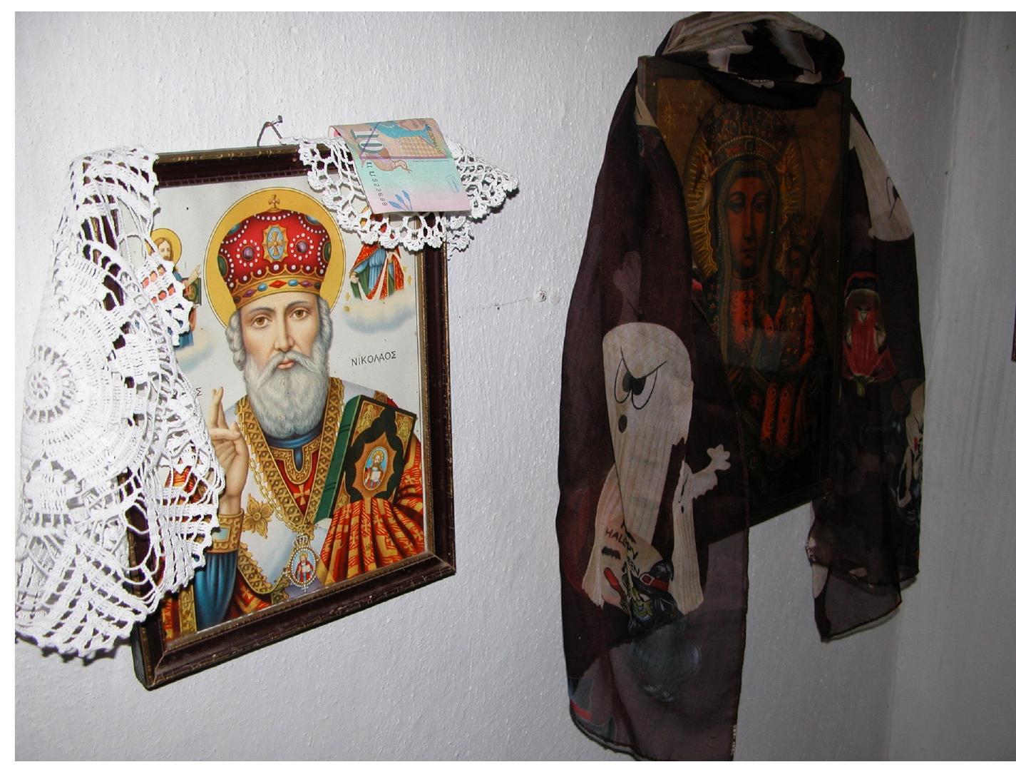 Icon of St. Nicholas in the H’d’t Baba Tekke/Church of St. Nicholas (Crkva Sveti Nikola), Makedonski Brod in western North Macedonia. Photograph © Glen Bowman.  Hadir (H’d’t) Baba. The Baba carries the name of and has since been conflated with the mythological Hizir (Xhidr) who, as mentioned earlier, is often seen to stand behind the saints Sari Saltuk (Sar’ Salt’k) and Nicholas.” In 1994 the local bishop officially consecrated a church at the shared sanctuary henceforth known both as Church of St. Nicholas (Crkva Sveti Nikola) and as H’d’r Baba Tekke. The mixed local population, however, still refers to it simply as “#irbe or wilbe. Each year Christian pilgrims gather together to honour the Translation of the Relics of St. Nicholas as well as the feast day of St. George on May 5—6 (also known as H’derlez) and Muslim pilgrims to honour the memory of Hadir Baba on May 6—7. Across from the entrance of the tomb, icons of St. Nicholas hang on the wall. It is on this side that Christian believers come to pray and light their candles, while the opposite side is reserved for Muslim devotions. When the Muslim pilgrims come, the Orthodox caretaker, presently a woman, replaces some of the Christian materializations of the sacred with Muslim religious paraphernalia, such as large prayer beads, and depictions of ‘Alid piety, such as ‘Ali, the Twelve Imams, and Bektasi saints.   Members of both the various Muslim denominations and North Macedonian Orthodox Christian communities participate in several ritual practices of the ‘other group’ — such as the exchange of coloured eggs, lighting candles, and the apotropaic rite of passing through long strings of prayer beads to obtain the holy man’s blessing and protection. Seeking health, well-being, and happiness for their families and themselves, members of both conceptual communities also visit the site for its well-known curative properties and take holy water and local herbs home with them. Pilgrims seeking the healing or transform- ative power of Sveti Nikola/H’d’r leave personal items, such as towels, blan- kets, shirts, or socks, overnight by or on the #irbe in the belief that this, like the water and the herbs, would help to heal a disease, cure infertility, and gain various other blessings. Unlike the examples discussed above, these practices 