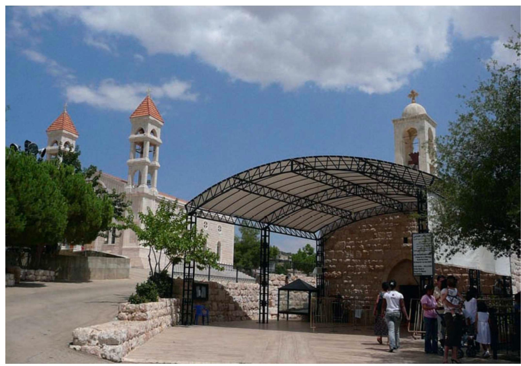 Fig. 4. The old and the new churches.  government. During the civil war, the LF distinguished themselves from other militias by the extensive use of symbolic markers in the territories they controlled. These included not only numerous posters of their leaders but also inscriptions placed on homes and buildings of their two emblems: a cedar tree in a red circle symbolizing the blood of the martyrs, and a red cross in the shape of a sword.” During the eleven years that their leader was imprisoned these symbols were outlawed. After the Syrian withdrawal from Lebanon in April 2005, and Samir Geagea’s release from prison in July, they began reappearing in pro-LF neighborhoods and villages. In Beshwat, in the immediate aftermath of Samir Geagea’s release, every house in the village had a poster of the LF leader and the young men proudly wore the LF’s red cross around their necks." 