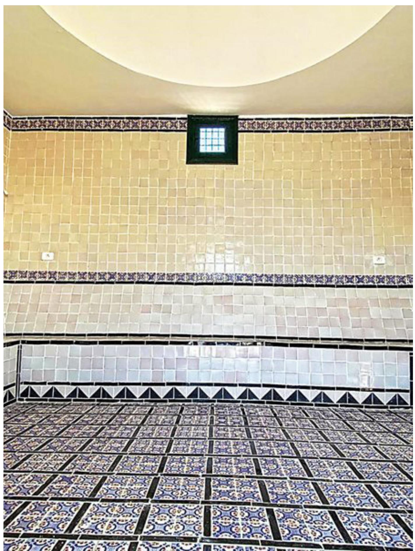 Fig. 6. Interior of the multi-faith prayer room, Le Jardin d’Afrique, Zarzis, Tunisia. Photograph © Rachid Koraichi.  An effort is made to include the death customs of different reli- gions and to address their ritual and symbolic meaning. The funeral rites at the gravesite follow mixed religious burial practices. If the ethnicity of a corpse can be determined, a resident of the same ethnicity from the nearby refugee shelter run by the Organisation internationale pour les migrations (OIM) is asked to say the funeral prayers in their native tongue (Fig. 8). Often Mongi Slim, Head of the Medenine branch of the Tunisian Red Crescent, is present at the Garden of Africa and assists with these rituals. In the various religions, fundamental values are revealed through death and its remembrance. In several religions, it is also believed that the way a body is prepared for burial has implications for the afterlife.” In Islam, drowning victims are considered martyrs (Sahth Bukhari 2674), which is why their bodies do not have to be ritually washed (ghus/) before burial. Wrapped in waterproof body bags, the bodies are placed in the dug graves in the sandy earth which is completely dry. The caretaker covers the grave with five large concave tiles and seals the joints with cement. The east-facing tombs are all directed towards the sunrise and Mecca.   Sajjad Rizbi, “A Muslim’s Perspective on the Good Death, Resurrection, and Human Destiny,” in Death, Resurrection, and Human Destiny: Christian and Muslim Perspectives, eds. David Marshall and Lucinda Mosher (Washington, DC: Georgetown University Press, 2014), 69. 