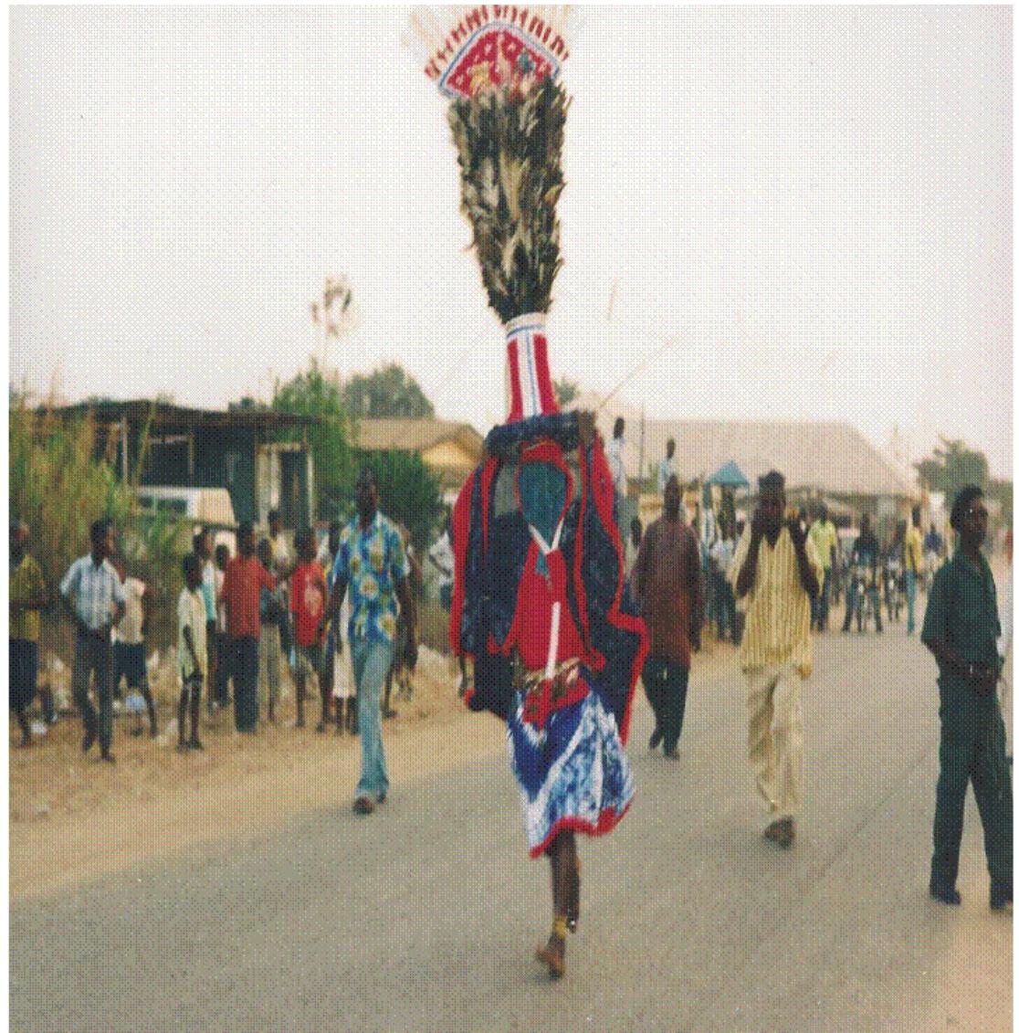 Fig. 4. Ukpalabor Masquerade in Performance (Field Work of Authors, 2020-2022)  The Ukpalabor masquerade is a crested mask built largely with feathers of all birds in varying co- lours. The Ukpalabor masquerade costume is a short, free and wide-shouldered flowing top designed with open sides, worn on a short skirt (nbénuku) like that of a flying bird, portraying the majesty, grace, speed and strength of the deity. The nature of the costume allows the masquerade to take fluid  steps and make symbolic gestures.  During the Igochi festival, which is purely a celebration of the people of Aballa-Unor, the Igochi masquerade performs. In November, towards the end of the farming season, it is usually commemo- rated as a year-end activity (Chief Stanley Olise, Personal Communication, 2019). The celebration is held to praise God for his protection, provision, and prosperity of the town, as well as for his guidance over the people throughout the year. The festival’s first stage is ritualistic, in which each family performs the rites in their homes before the accompanying festivities, while the second part  The Ukpalabor masquerade is a crested mask built largely with feathers of all birds in varying co:  The celebration of the Ukpalabor festival is not limited to a single community in the Ndokwa are ut is shared by several. It is not, however, observed at the same time each year, even though eac community’s religious significance and essence are the same. The event, which is supposed to buil and solidarity, takes place in the dry season after harvest in some communities between October an November, and in others between February and March, just before the new planting season (Chie Monday Obi, Personal Communication, 2019). The Ukpalabor masquerade is very colourful and beat ‘iful as it represents the deity of the people. The masquerade’s goal is to cast curses on evildoer: ourify the land of evil, and bring the people in amidst great celebration, dancing, and merrymaking 
