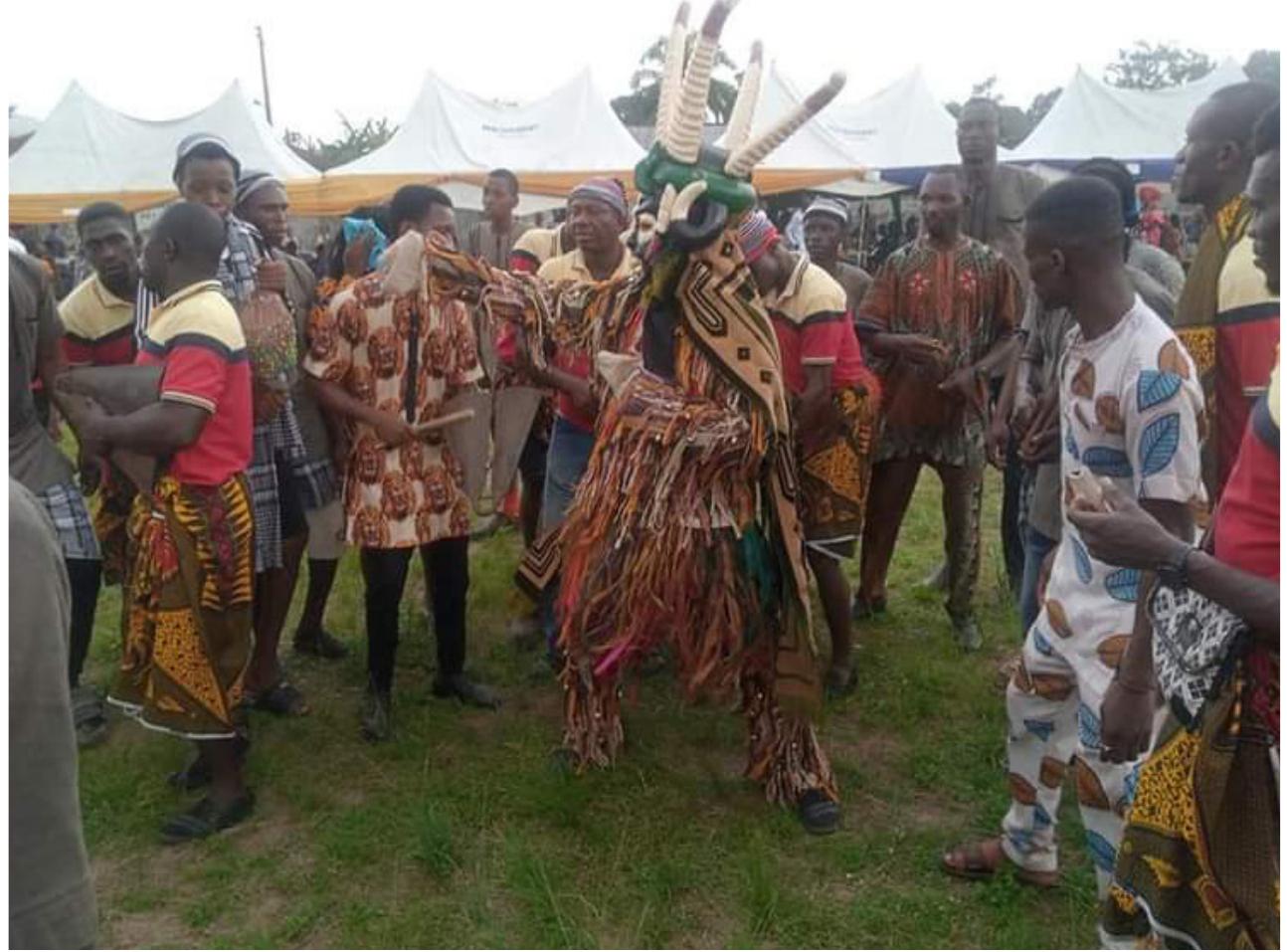 Fig. 6. Odogwu in Performance (Field Work of Authors, 2020-2022)  de, though masculine in nature but showcases feminine features with a beautiful white or black silky human hair mask. The Odogwu masquerade is aggressive with a frightening mask, which may include human heads, figurines, reptiles, water creatures, or predatory fish, and may be multicoloured with various ornaments and embellishments. It exudes youthful strength through the use of a mask that  suggests revolt and intimidation. 